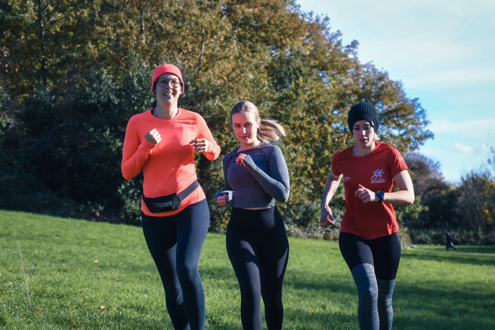 group of people running in a park
