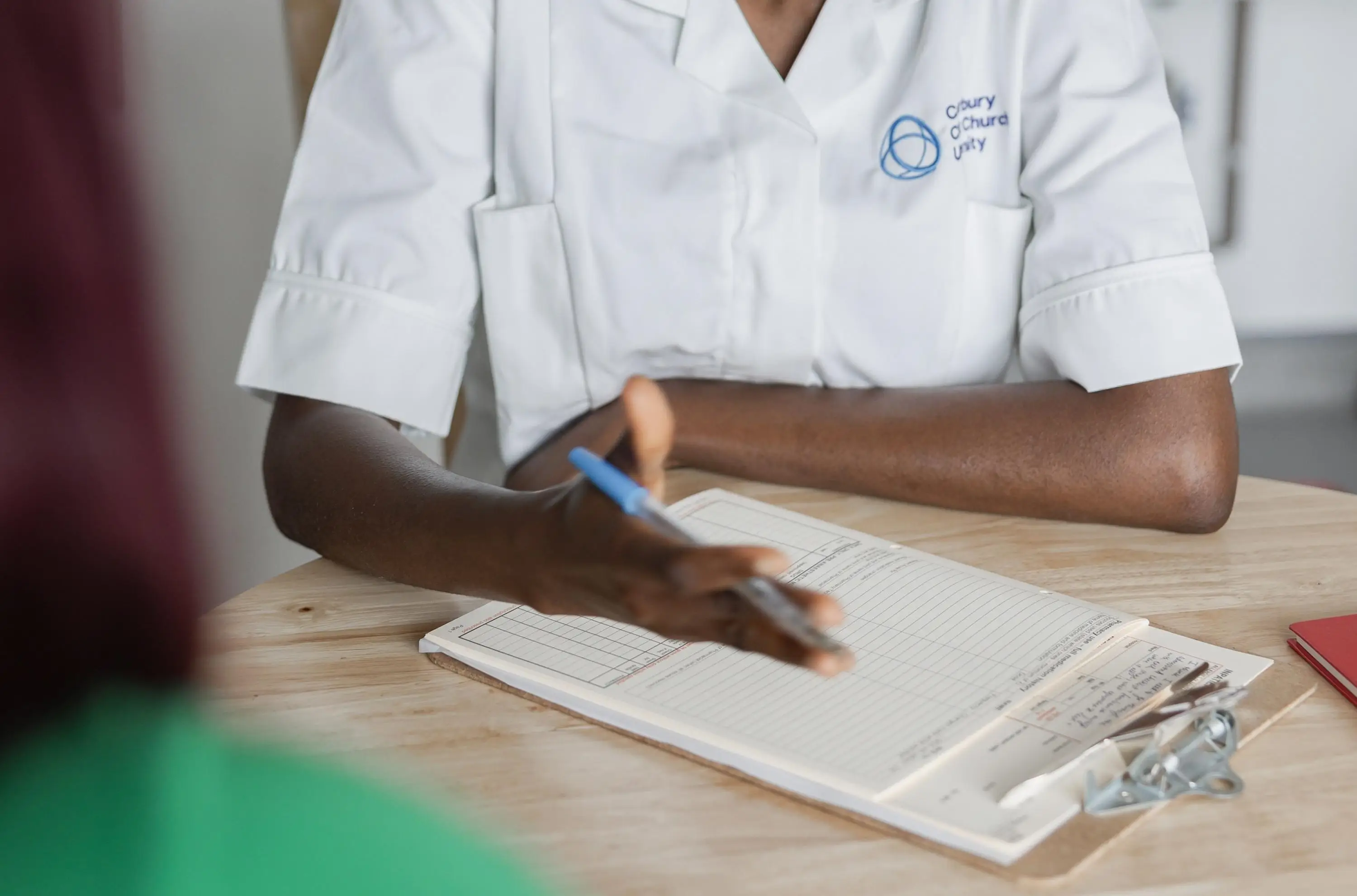 A health practitioner sat with client
