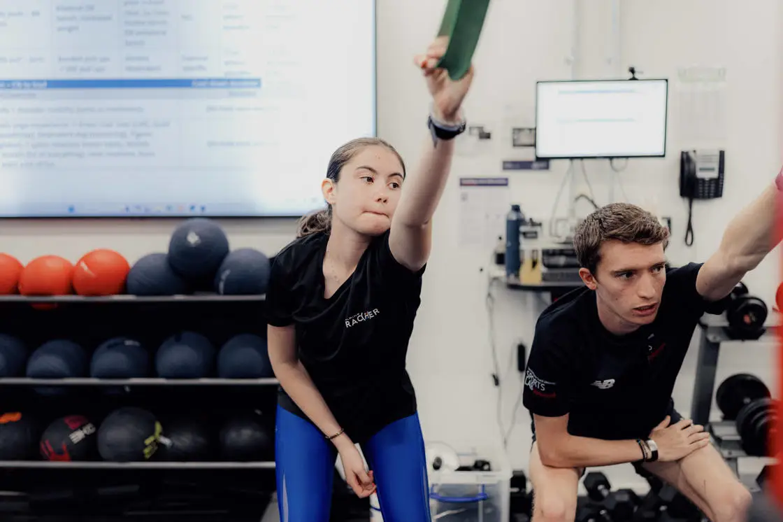 Girl testing stretch capacity with SportsLab technician 